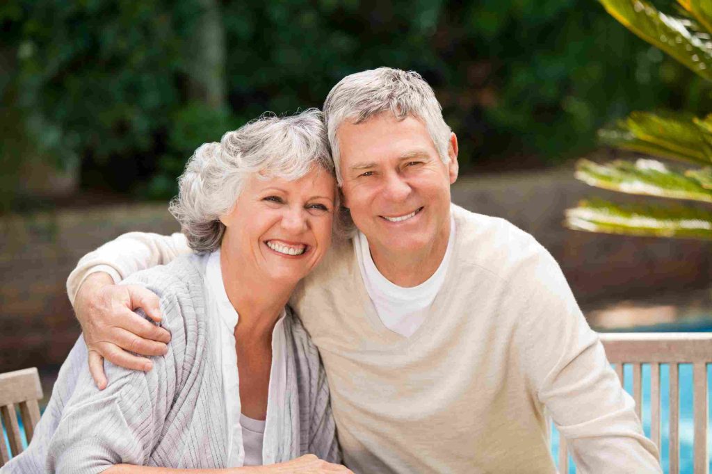 senior couple hugging garden